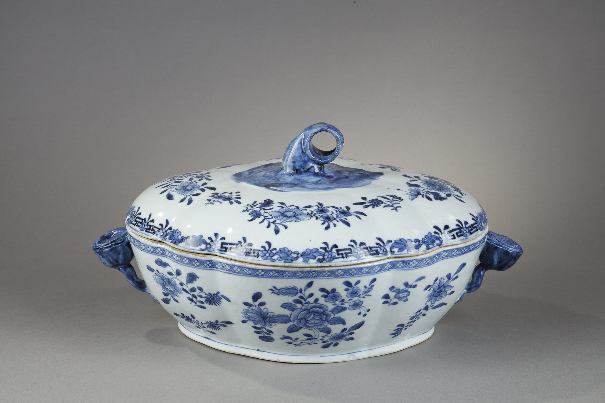 Tureen and its cover in blue white porcelain from a European orfevrerie model - flowers shaped handles